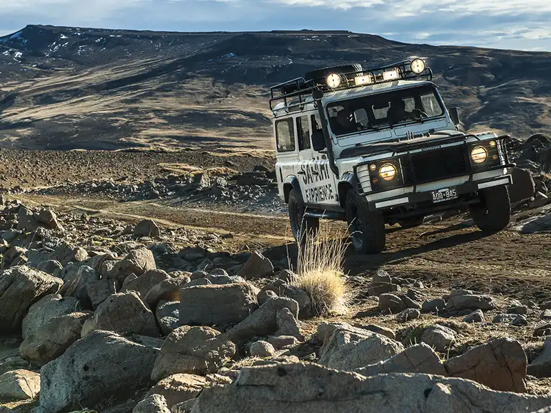 Camioneta 4x4 del Safari Experience en movimiento por los senderos de la estepa, travesía todoterreno frente al Lago Argentino.